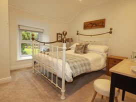 A bedroom with a bed and a desk at Seveock in Threemilestone