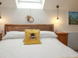 A bedroom with a bed and wall art at Seveock in Threemilestone