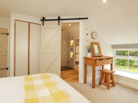 A bedroom with a bed and a shower room visible at Seveock in Threemilestone