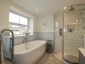 A bathroom with a bathtub and shower at Seveock in Threemilestone