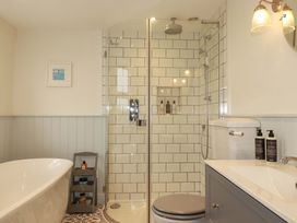 A bathroom with a bathtub and shower in Seveock Threemilestone