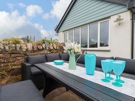 A garden seating area with table and chairs at Seveock in Threemilestone