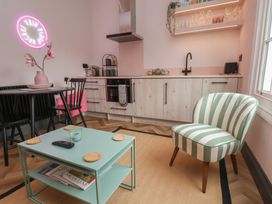 A kitchen with a dining table and chairs at Apartment Pink in 