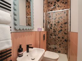 A bathroom featuring a shower and sink at Apartment Pink