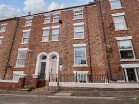 A facade of a brick building with windows and a door at Apartment Pink in Whitby