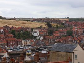 A view of a harbor with houses and boats at Apartment Pink in Whitby