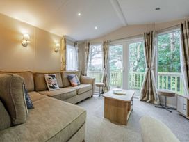A living room with a sofa and coffee table at Bingos Cabin in Holt