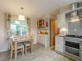 A kitchen with a table set for dining at Bingos Cabin in Holt