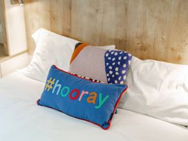 Two pillows on a bed at Bingos Cabin in Holt