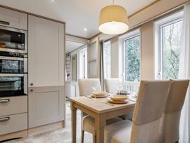 A dining room with a table and chairs at Four Seasons in Holt