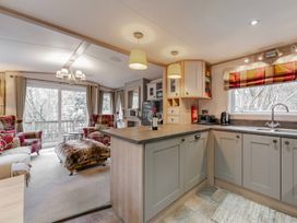 A kitchen with a sink and appliances at Four Seasons in Holt
