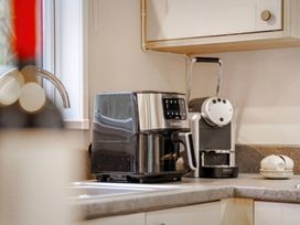 A kitchen with an air fryer and coffee maker at Four Seasons in Holt