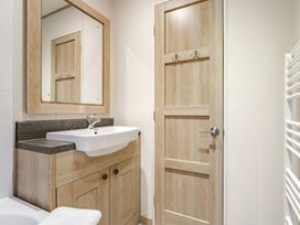 A bathroom with a sink and mirror at Four Seasons in Holt