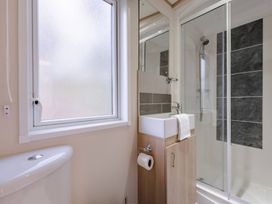 A bathroom with a sink and shower at Four Seasons in Holt