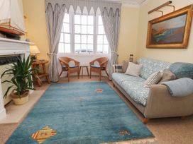 A living room with a couch and rug at No 3 By The Sea in Weymouth