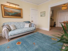 A living room with a sofa and painting at No 3 By The Sea in Weymouth