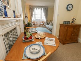 A dining room with a table set for a meal at No 3 By The Sea in Weymouth