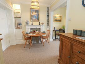 A dining room with a table and chairs at No 3 By The Sea in Weymouth