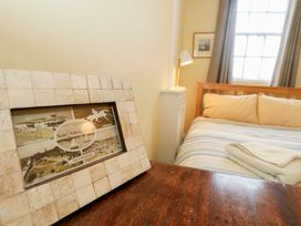 A bedroom with a bed and picture frame at No 3 By The Sea in Weymouth