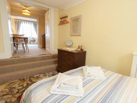 A bedroom with a bed and towels on the bed at No 3 By The Sea in Weymouth