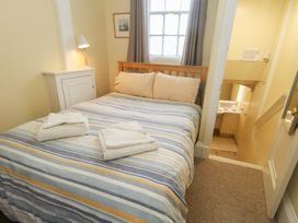 A bedroom with a bed and towels at No 3 By The Sea in Weymouth