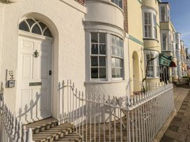 A front entrance with a white door and windows at Number 3 by the Sea in Weymouth