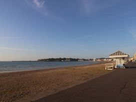 A beach with sea and promenade at Number 3 by the Sea in Weymouth