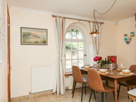 A dining room with a table and chairs at Gorway Cottage in Teignmouth