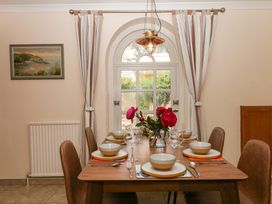A dining room with a table set for a meal at Gorway Cottage Teignmouth