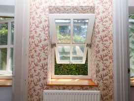 A window with an open top section and a radiator at Gorway Cottage in Teignmouth