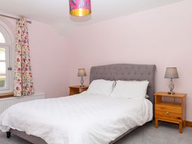 A bedroom with a bed and bedside tables at Gorway Cottage Teignmouth