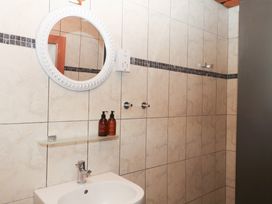 A bathroom with a sink and mirror at Gorway Cottage Teignmouth