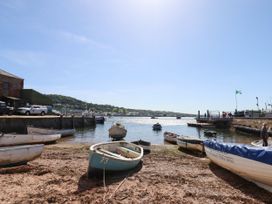 A view of boats at a waterfront with hills in the background at Gorway Cottage in Teignmouth