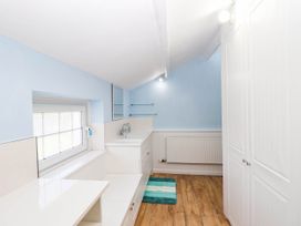 A laundry room with a sink and storage at Swallow Cottage Sheviock near Crafthole