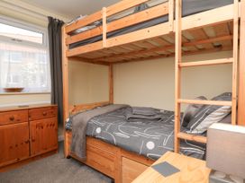 A bedroom with a bunk bed and a cabinet at Wheeldale Cottage in Goathland