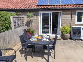 An outdoor dining area with a table set at Wheeldale Cottage in Goathland
