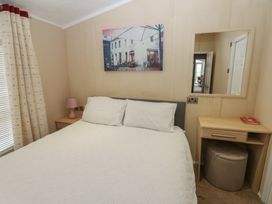 A bedroom with a double bed and bedside table at Plot 34 Carlisle