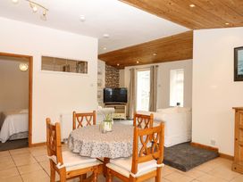A dining room with a table and chairs at The Headmasters Quarters in Chudleigh