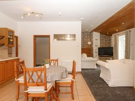 A living room with dining area and sofa at The Headmasters Quarters in Chudleigh