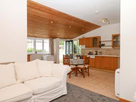 A kitchen with a dining area and sofa at The Headmasters Quarters in Chudleigh