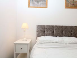 A bedroom with a bed and bedside table at The Headmasters Quarters in Chudleigh