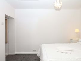 A bedroom with a bed and a bedside table at The Headmasters Quarters Chudleigh