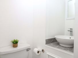 A bathroom with a toilet and sink at The Headmasters Quarters in Chudleigh