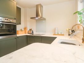 A kitchen with appliances and cabinets at 8 Yellow Sands in Padstow