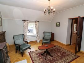 A living room with armchairs and a table at Gullane East in Rathmore, County Kerry