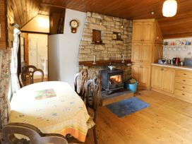 A kitchen with a dining table and stove at Gullane East in Rathmore, County Kerry