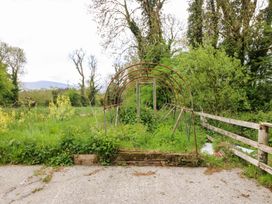 An arch structure surrounded by grass and trees at Gullane East in Rathmore, County Kerry