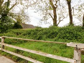 A rural scene with a wooden fence and trees at Gullane East in Rathmore, County Kerry