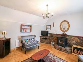 A living room with a sofa and a television at Gullane East in Rathmore, County Kerry