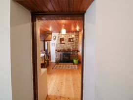 A dining room with a fireplace and dining table at Gullane East in Rathmore, County Kerry